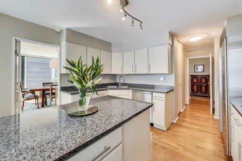 a large bed sitting in a bedroom next to a window