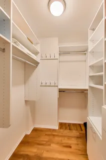 a spacious bedroom with a bed and a couch next to a window