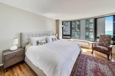 a bedroom with a large bed and a large window