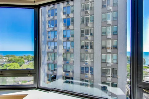 a bathroom with a granite countertop sink toilet a mirror and shower
