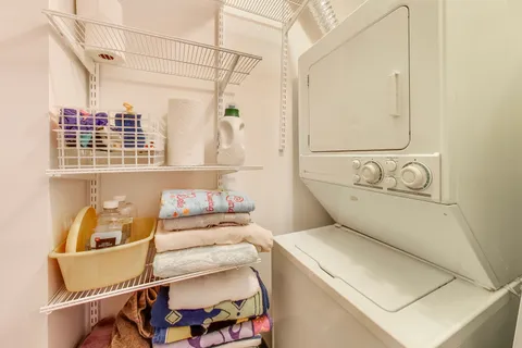 a view of a room with gym equipment and floor to ceiling window