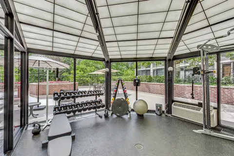 a room with gym equipment and a large window