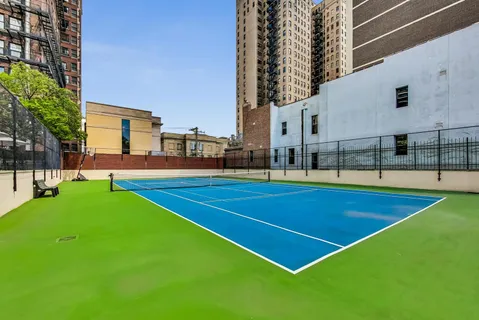a view of a bedroom with wooden floor