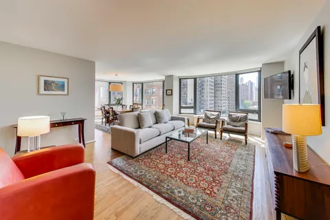 a living room with furniture and a rug