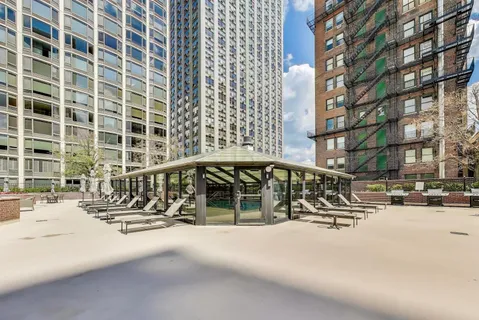 a living room with furniture and a mirror