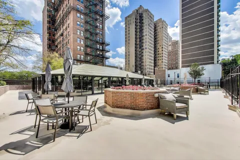 a hallway with a large window and furniture