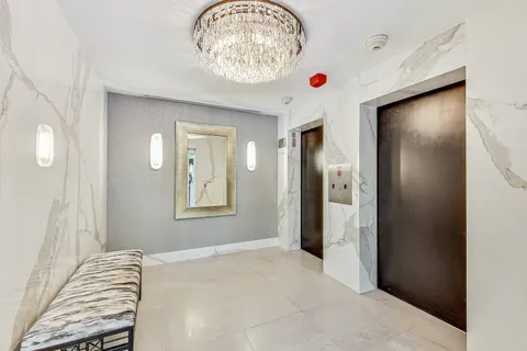 a view of washer and dryer with kitchen in the background