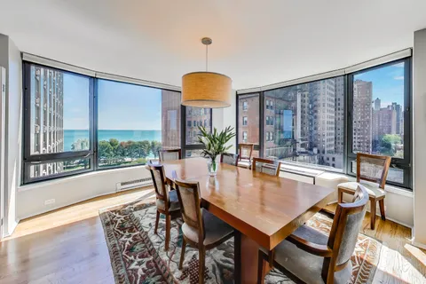 a view of a dining room with furniture and a large window
