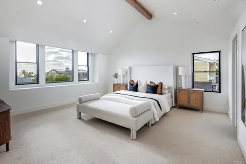 a bedroom with a bed and a large window