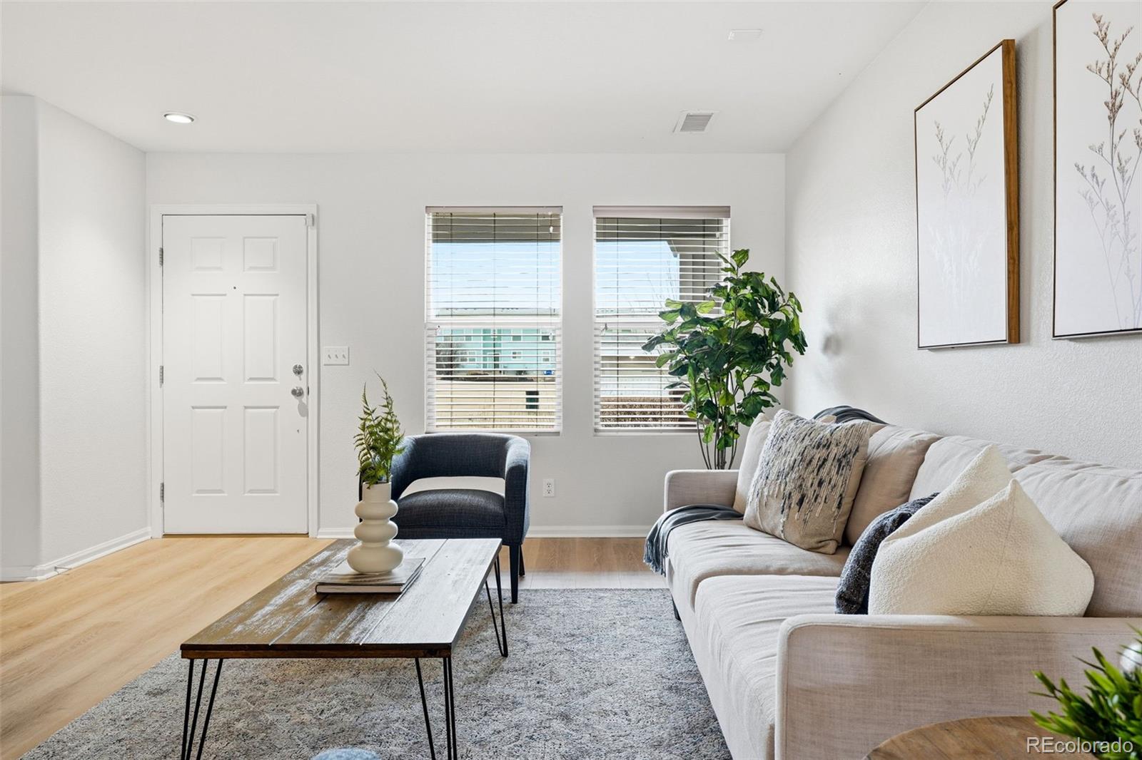 5811 Ceylon Street Denver, CO 80249 - Photo 11 of 43 a living room with furniture and a potted plant
