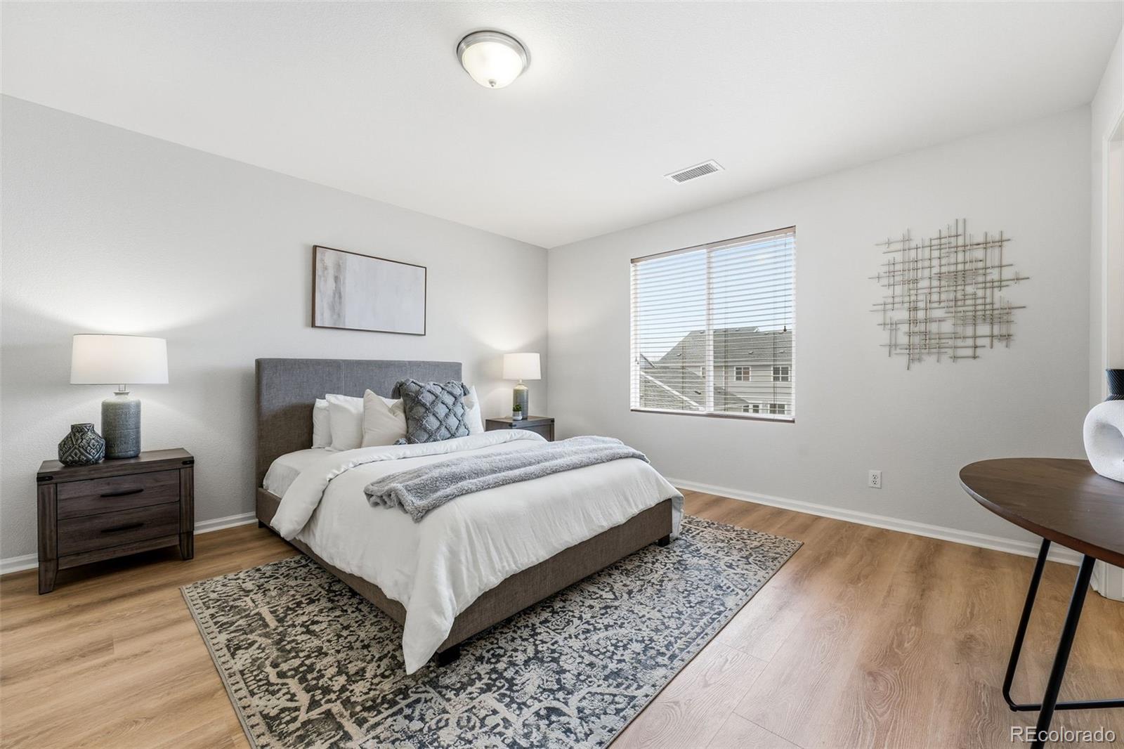 5811 Ceylon Street Denver, CO 80249 - Photo 25 of 43 a bedroom with a bed and a window