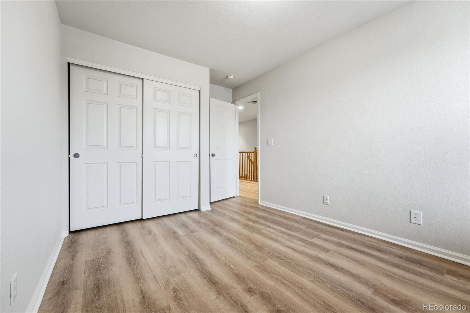 5811 Ceylon Street Denver, CO 80249 - Photo 31 of 43 a view of an empty room and wooden floor