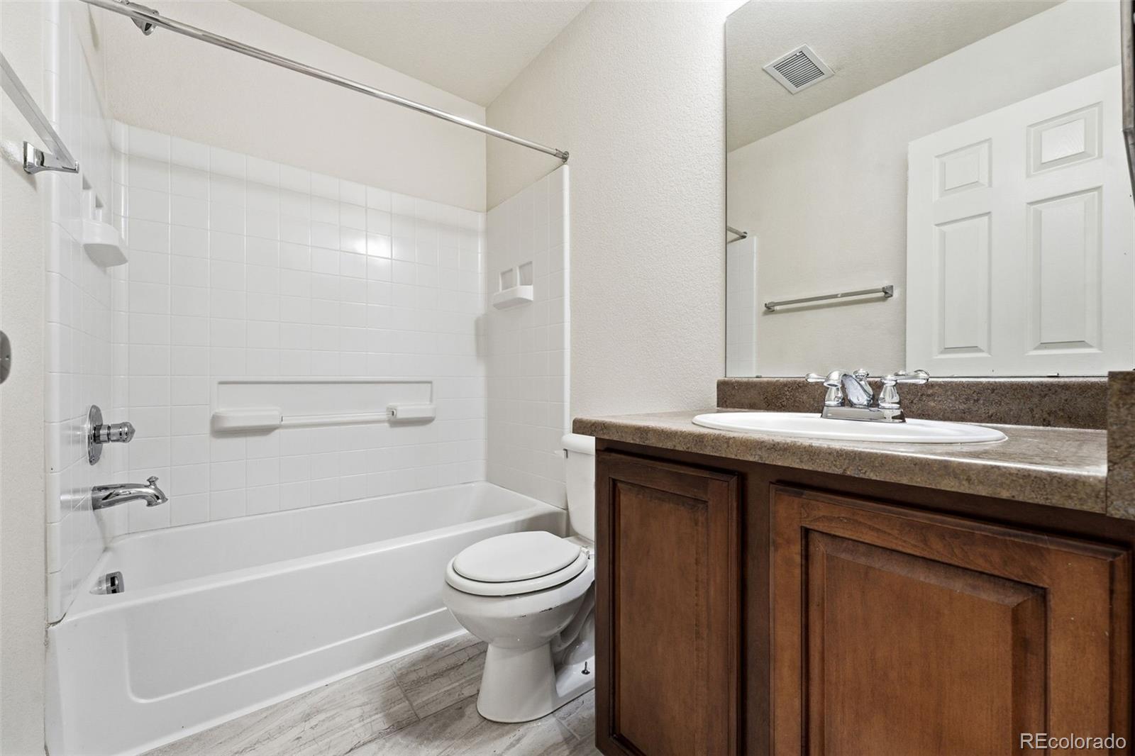 5811 Ceylon Street Denver, CO 80249 - Photo 32 of 43 a bathroom with a sink a toilet and a bathtub