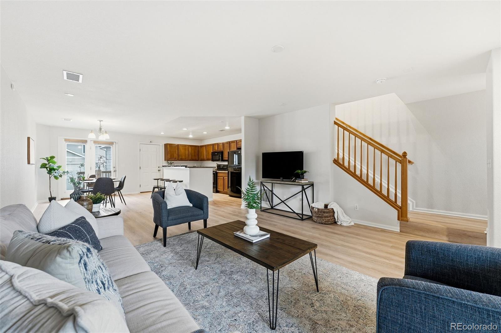5811 Ceylon Street Denver, CO 80249 - Photo 6 of 43 a living room with furniture and a flat screen tv