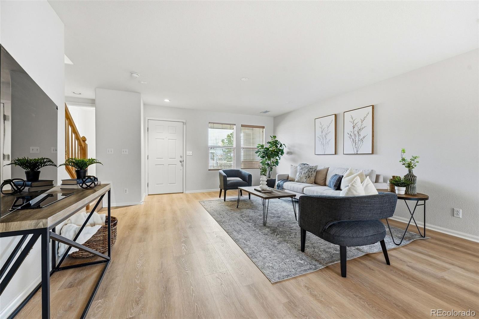 5811 Ceylon Street Denver, CO 80249 - Photo 10 of 43 a living room with furniture and wooden floor