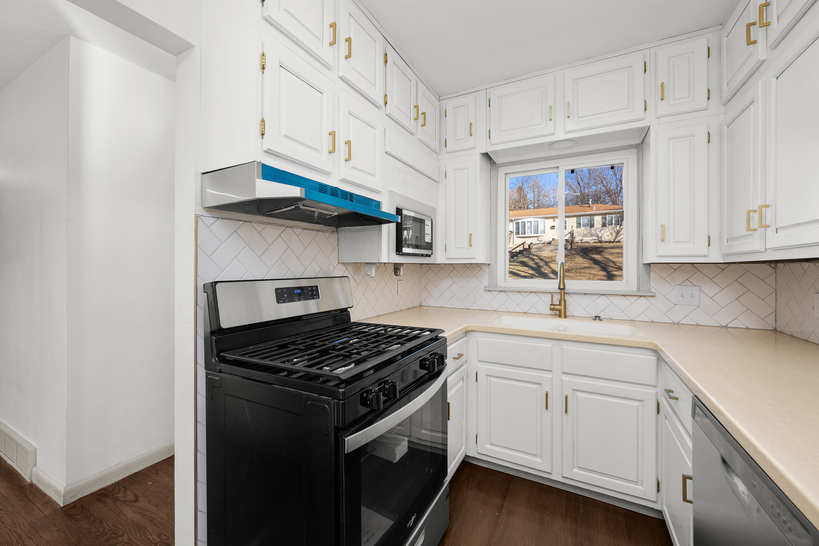 2518 13th Street Rock Island, IL 61201 - Photo 13 of 37 a kitchen with white cabinets and appliances