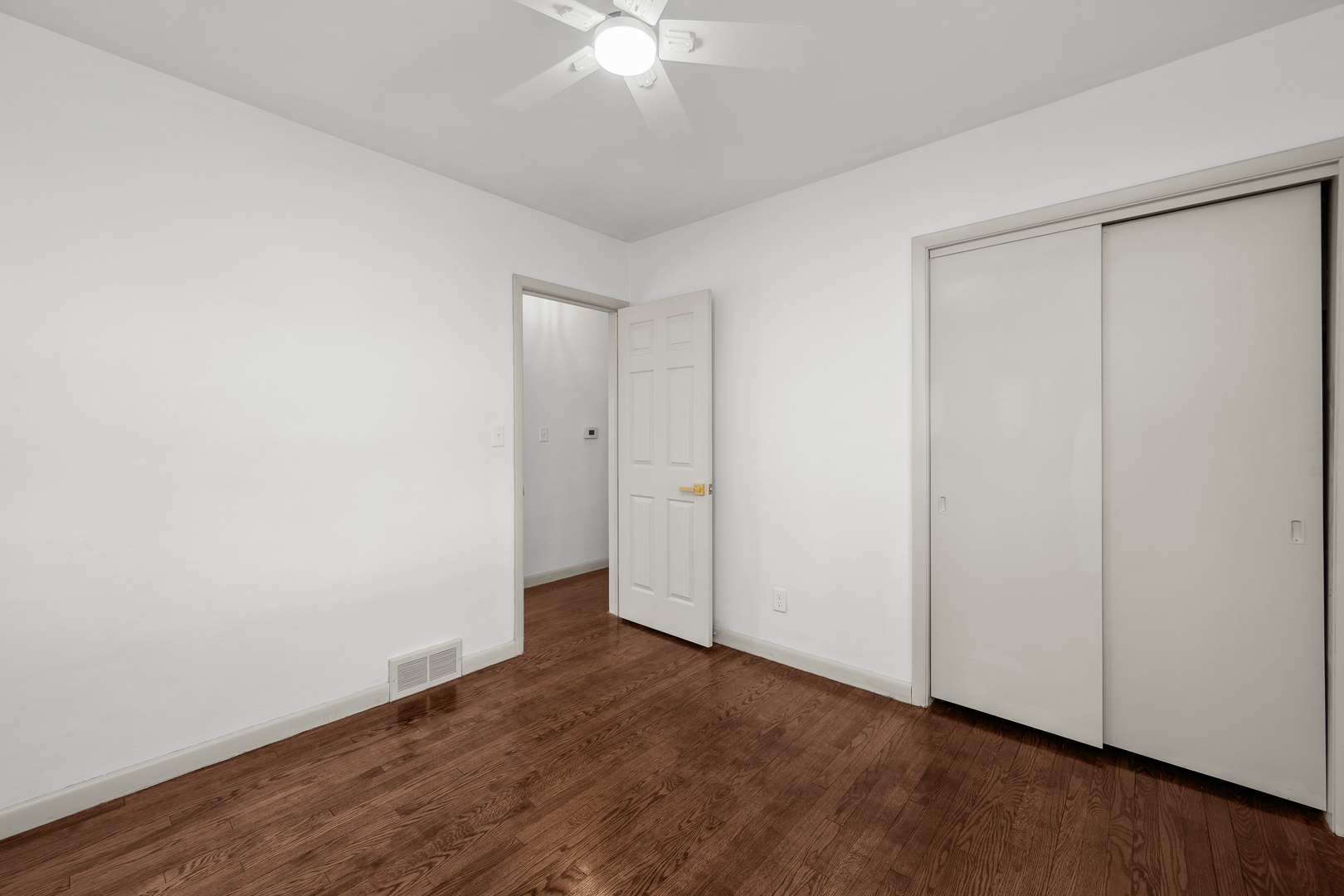 2518 13th Street Rock Island, IL 61201 - Photo 16 of 37 an empty room with wooden floor and fan