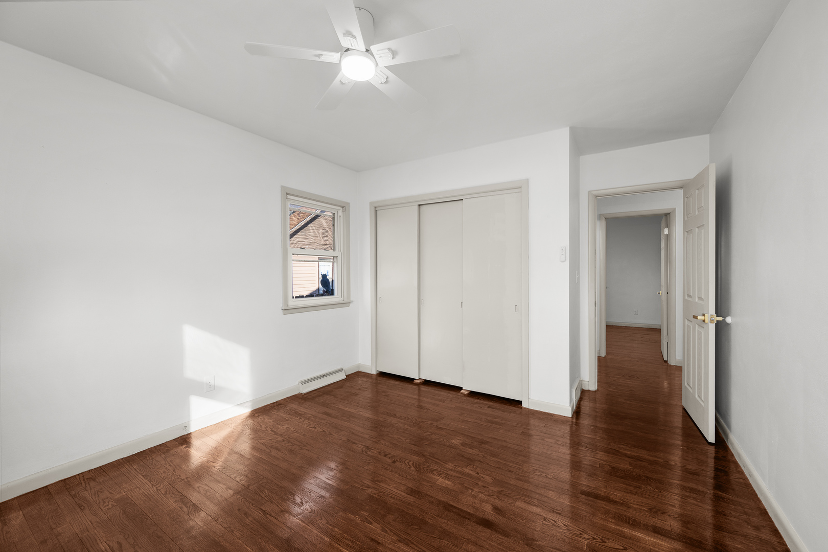 2518 13th Street Rock Island, IL 61201 - Photo 19 of 37 an empty room with wooden floor and ceiling fan
