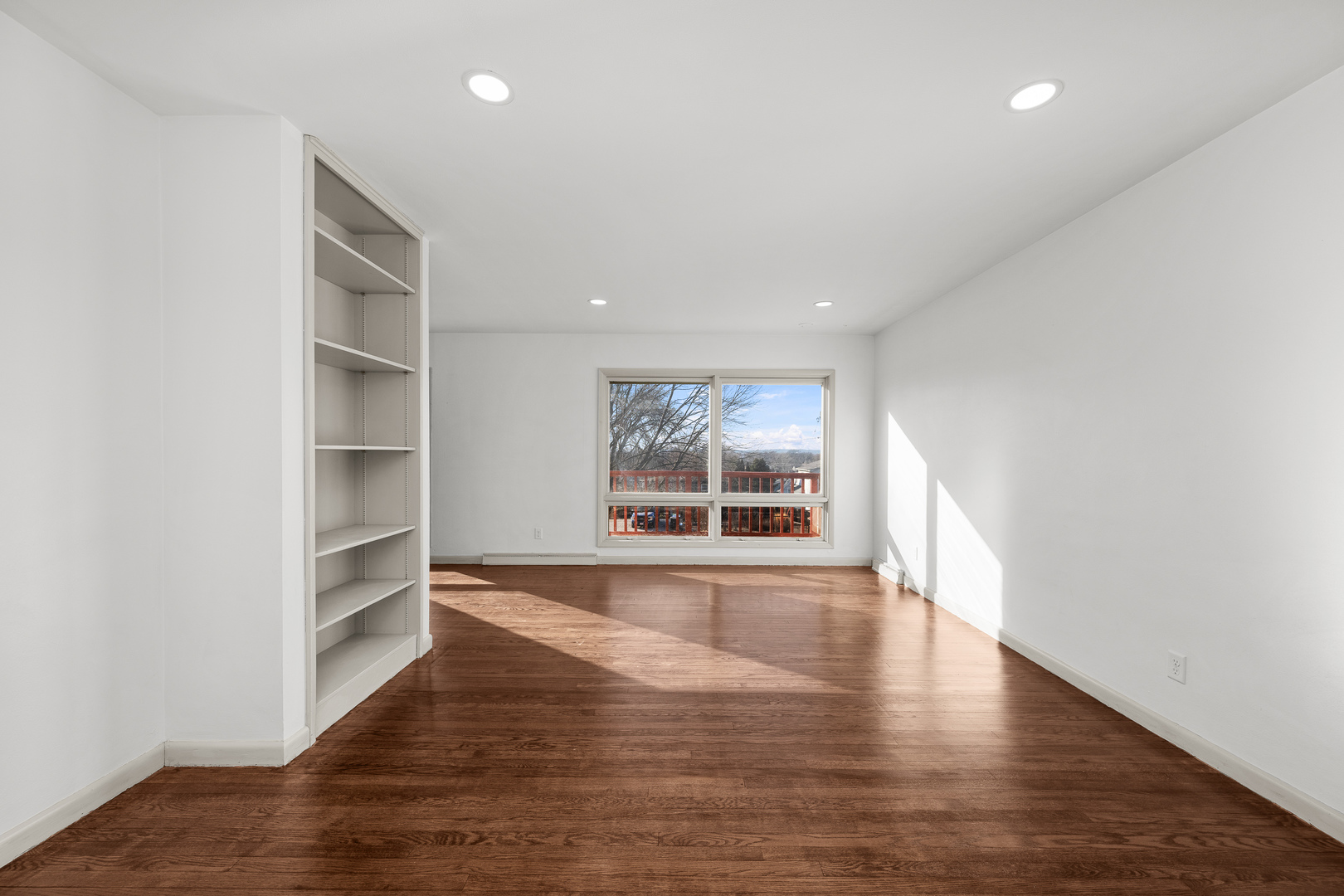 2518 13th Street Rock Island, IL 61201 - Photo 4 of 37 a view of an empty room with a window and wooden floor