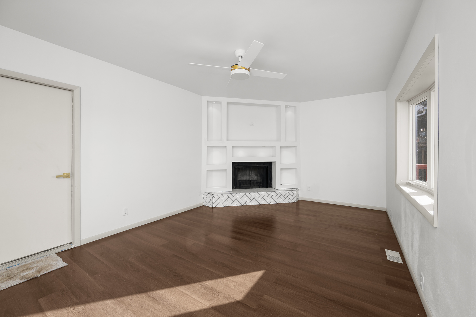 2518 13th Street Rock Island, IL 61201 - Photo 10 of 37 an empty room with wooden floor fireplace and windows
