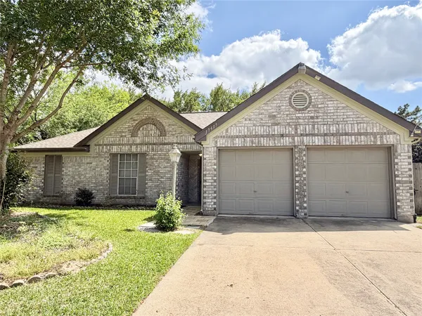 a view of a house with a yard and garage