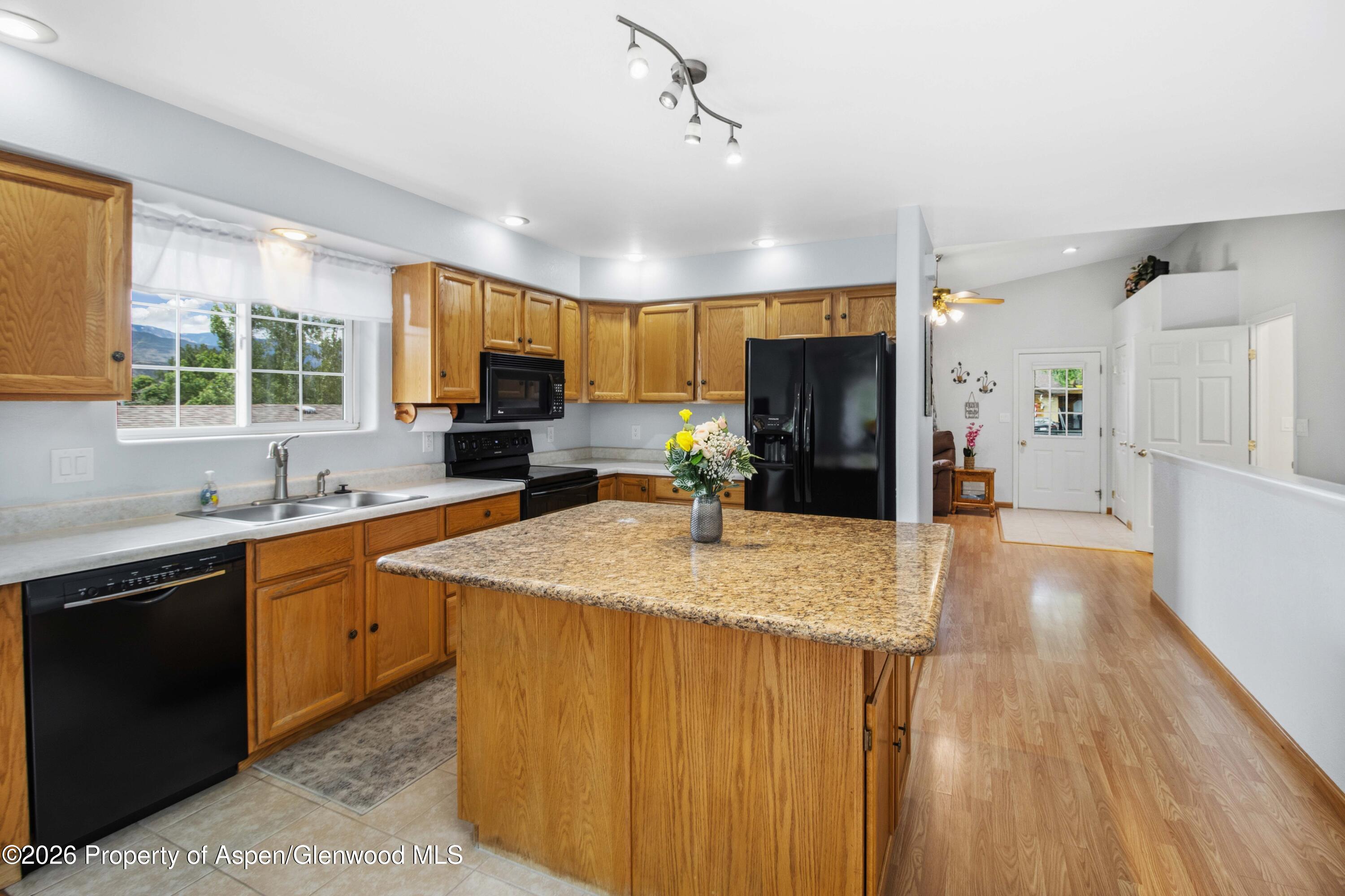 660 Aspen Avenue Rifle, CO 81650 - Photo 6 of 30 a kitchen with stainless steel appliances granite countertop a sink stove and refrigerator
