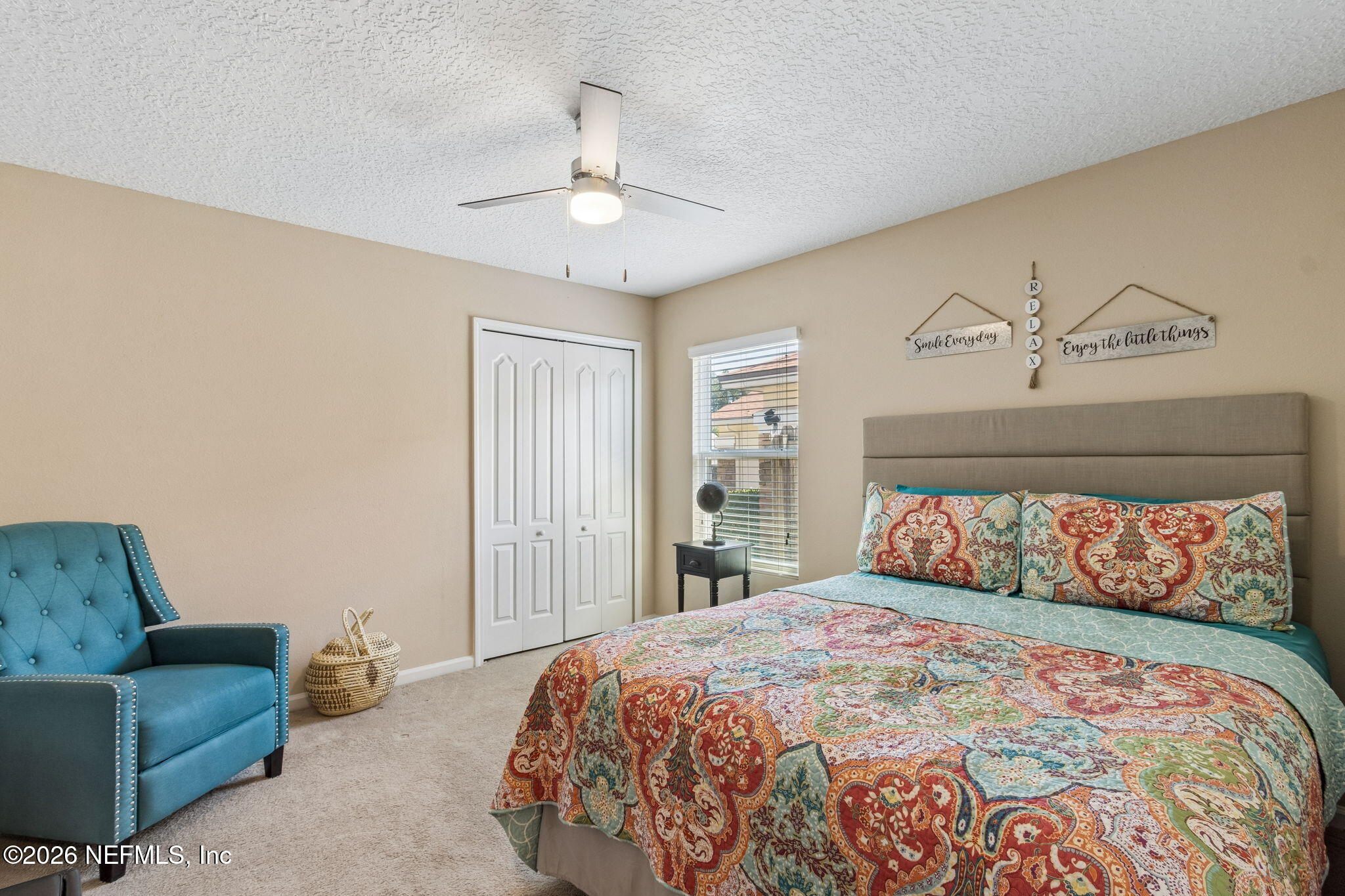 96034 Bass Lane Yulee, FL 32097 - Photo 34 of 50 a bedroom with a large bed and a couch