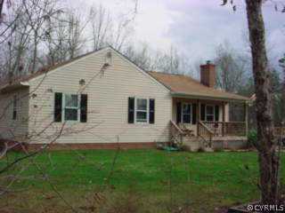 a front view of house with yard and outdoor seating