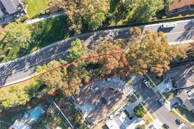 a view of a street with large trees
