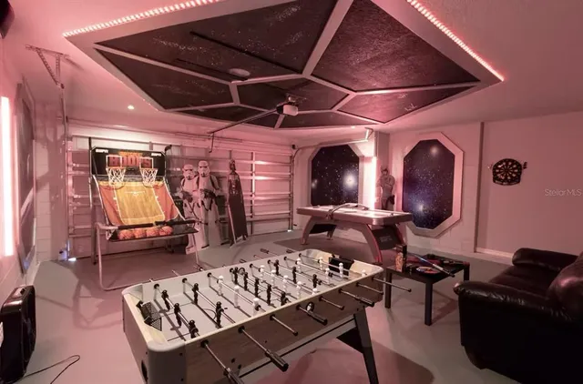 a dining room with furniture and chandelier