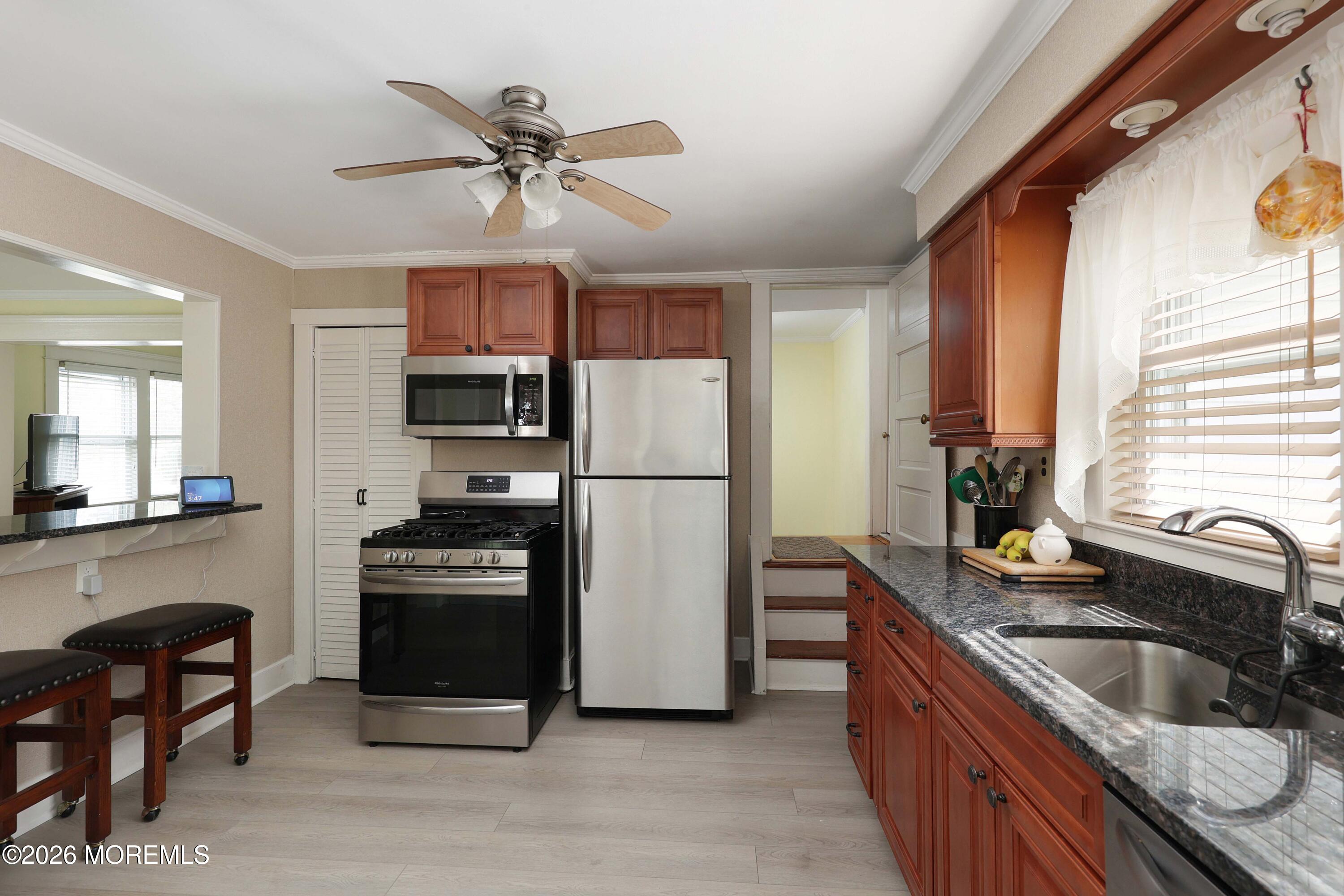 715 Howe Street Point Pleasant, NJ 08742 - Photo 11 of 45 a kitchen with stainless steel appliances granite countertop a refrigerator a sink a stove a washer and a refrigerator