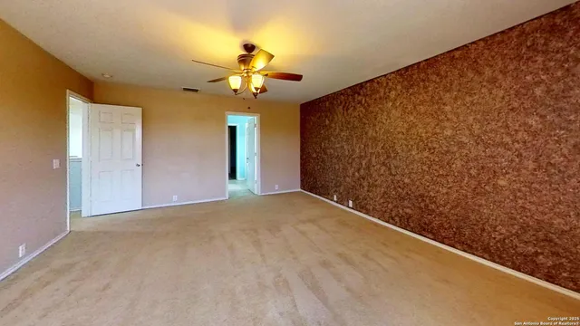 a view of a chandelier fan and closet in a room