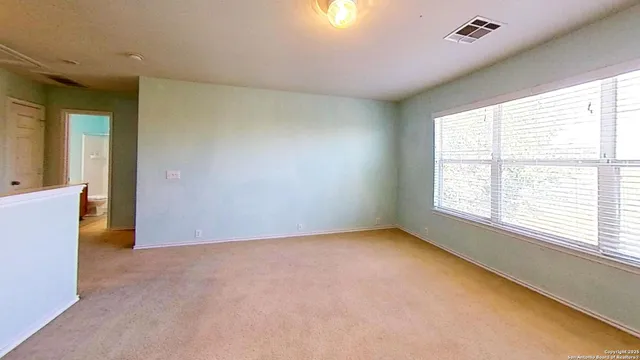 a view of an empty room with a window