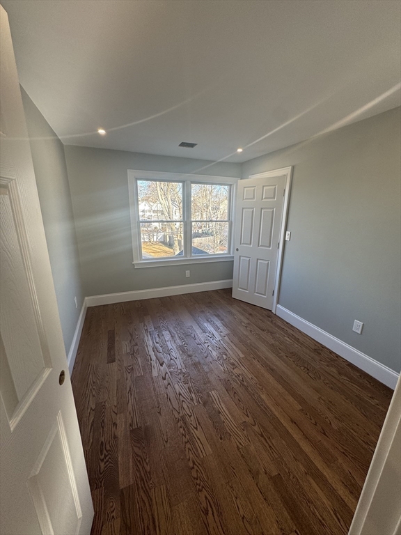 12 Bronx Road Boston, MA 02132 - Photo 11 of 31 wooden floor in an empty room with a window
