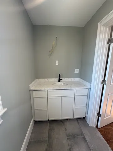 a bathroom with a sink and vanity