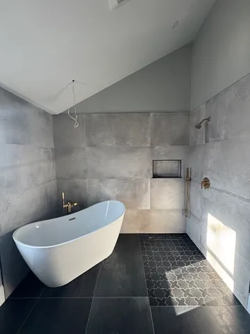 a bathroom with a sink a toilet and a window