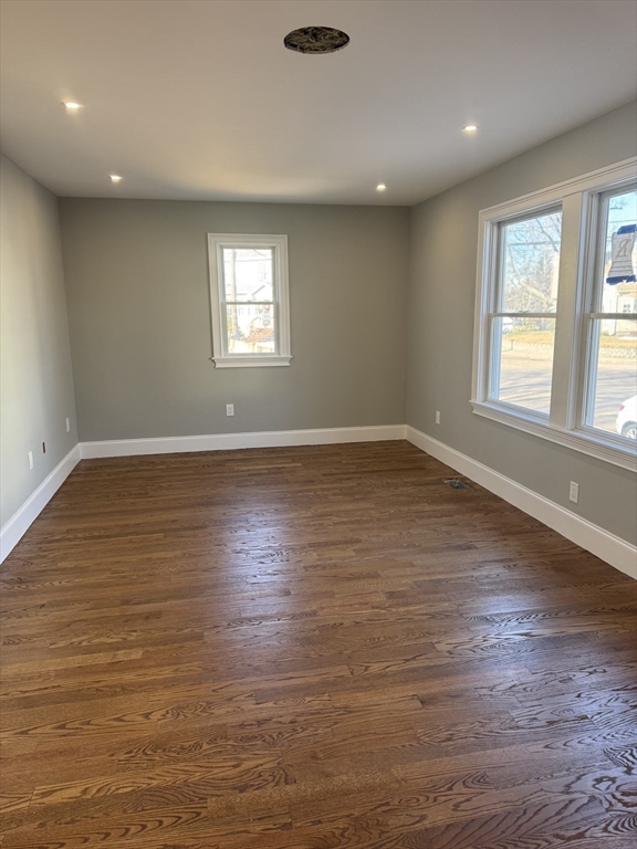 12 Bronx Road Boston, MA 02132 - Photo 6 of 31 an empty room with wooden floor and windows