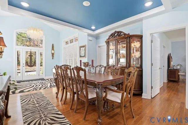 a view of a a dining room with furniture window and wooden floor