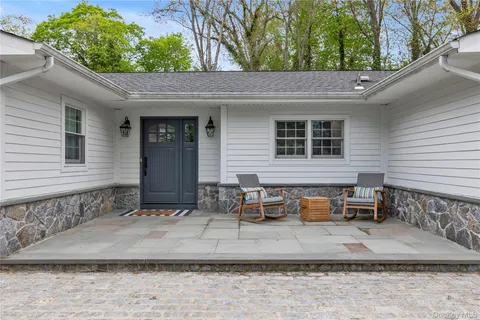 a backyard of a house with outdoor seating