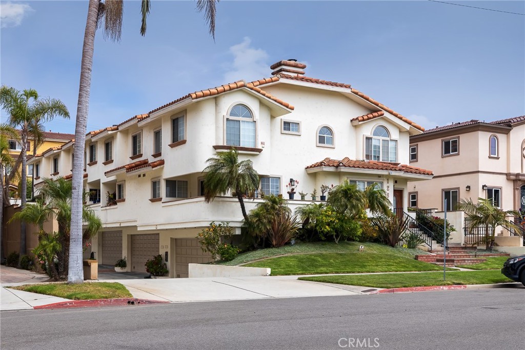 128 South Broadway, Unit E Redondo Beach, CA 90277 - Photo 1 of 1 a view of white house with a yard and plants