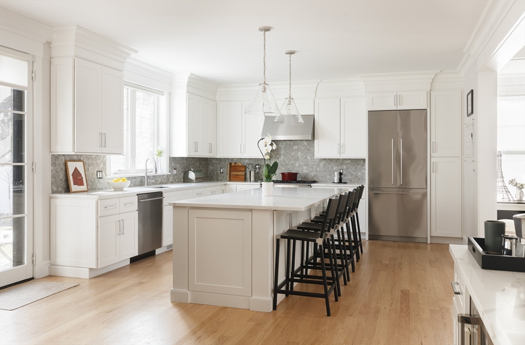 36 Patton Road Wellesley, MA 02482 - Photo 5 of 24 a kitchen with white cabinets and stainless steel appliances