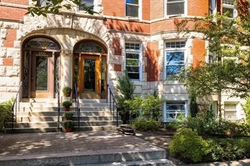 a view of building with a couple of potted plants