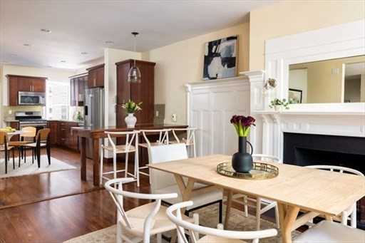 1898 Beacon Street, Unit 4 Brookline, MA 02445 - Photo 4 of 13 a living room with furniture a fireplace and kitchen view