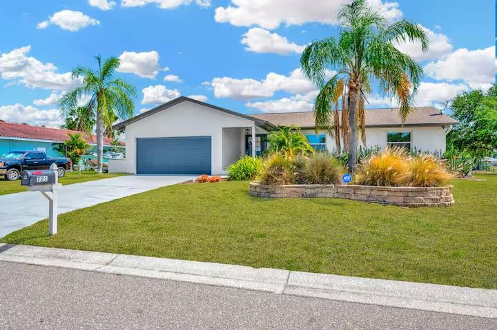 721 Eagle Lane Apollo Beach, FL 33572 - Photo 2 of 48 a front view of a house with garden