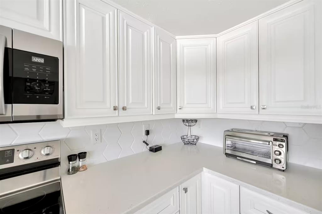 721 Eagle Lane Apollo Beach, FL 33572 - Photo 21 of 48 a kitchen with stainless steel appliances granite countertop white cabinets and a refrigerator a sink