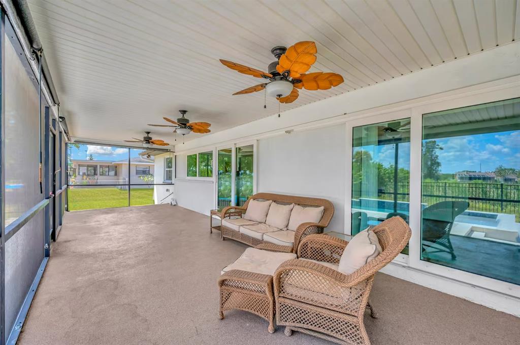 721 Eagle Lane Apollo Beach, FL 33572 - Photo 36 of 48 a living room with patio furniture and a floor to ceiling window