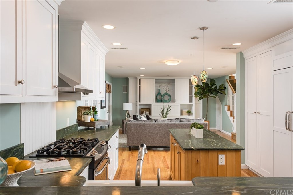 107 High Drive Laguna Beach, CA 92651 - Photo 17 of 35 a kitchen with stainless steel appliances granite countertop a stove and white cabinets with wooden floor