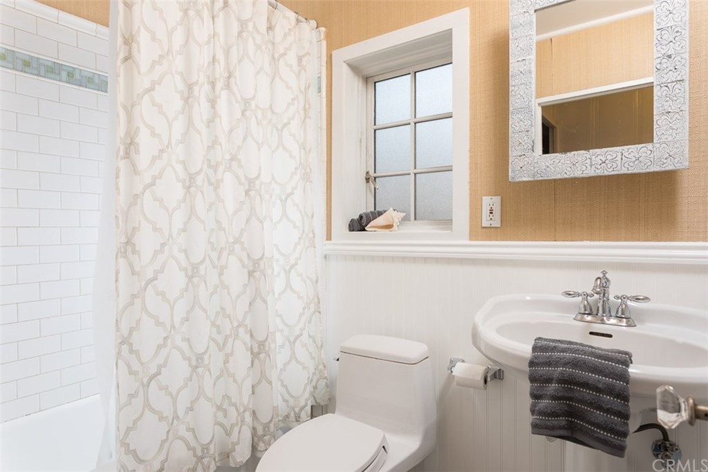 107 High Drive Laguna Beach, CA 92651 - Photo 24 of 35 a bathroom with a sink a toilet and shower curtain