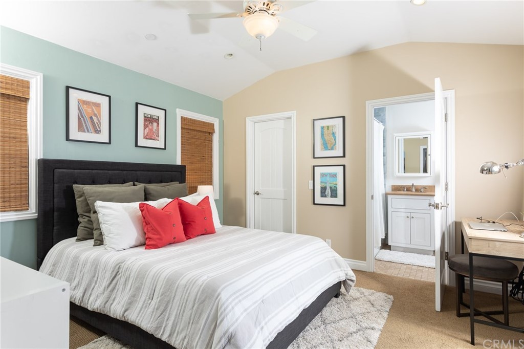 107 High Drive Laguna Beach, CA 92651 - Photo 8 of 35 a bedroom with a large bed and a chandelier