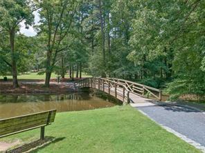 23 Chelsea Court Avondale Estates, GA 30002 - Photo 24 of 25 a view of a lake with a bench and trees around